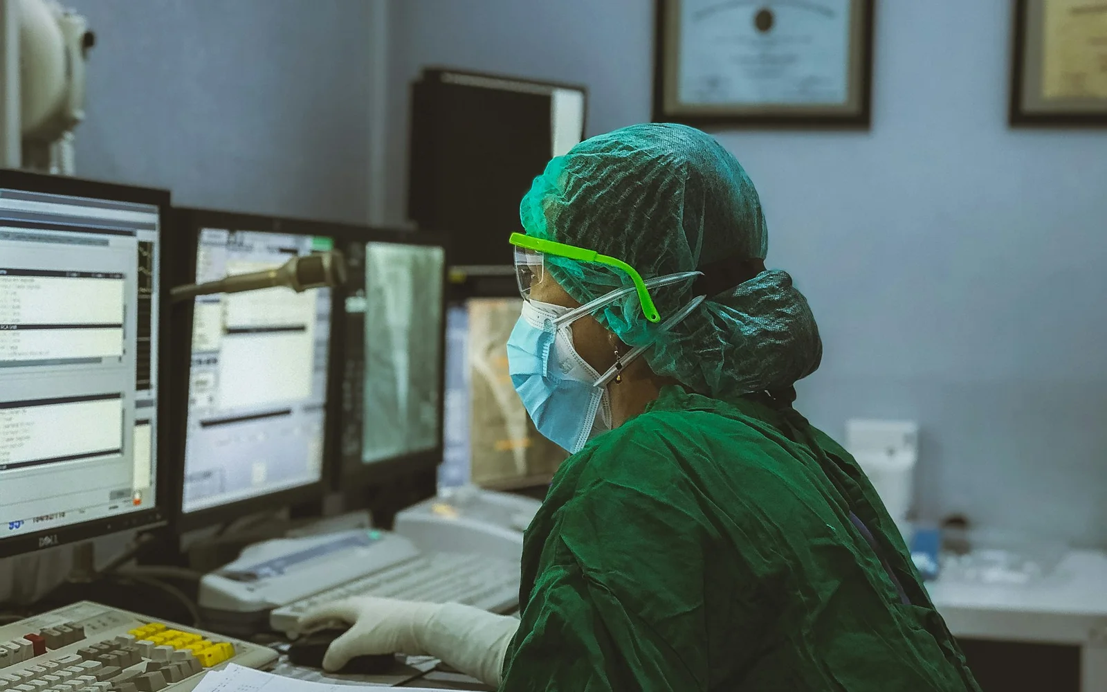 Clinician reviewing diagnostic information and documents at a secure workstation
